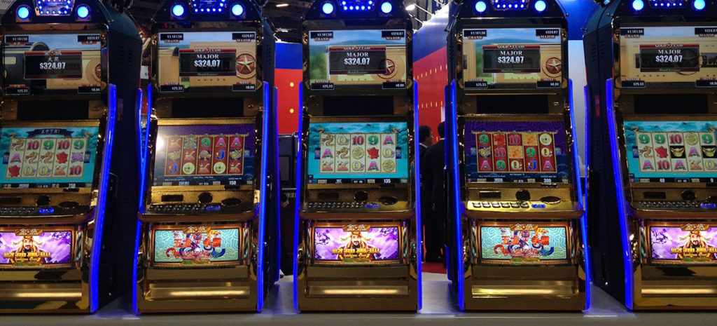 An image of colorful slot machines - Gaming Compliance is a necessary component of operating a successful company in the regulated gaming markets. Gaming Compliance is actually made up of two components, Legal Compliance and Technical Compliance.